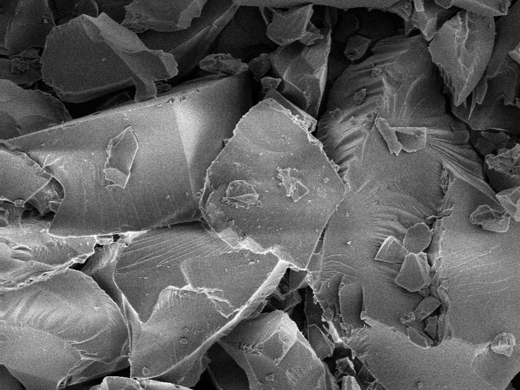 Scanning electron micrograph of Silexa's silica ion-exchange material, showing angular, fracture-free mineral particles
